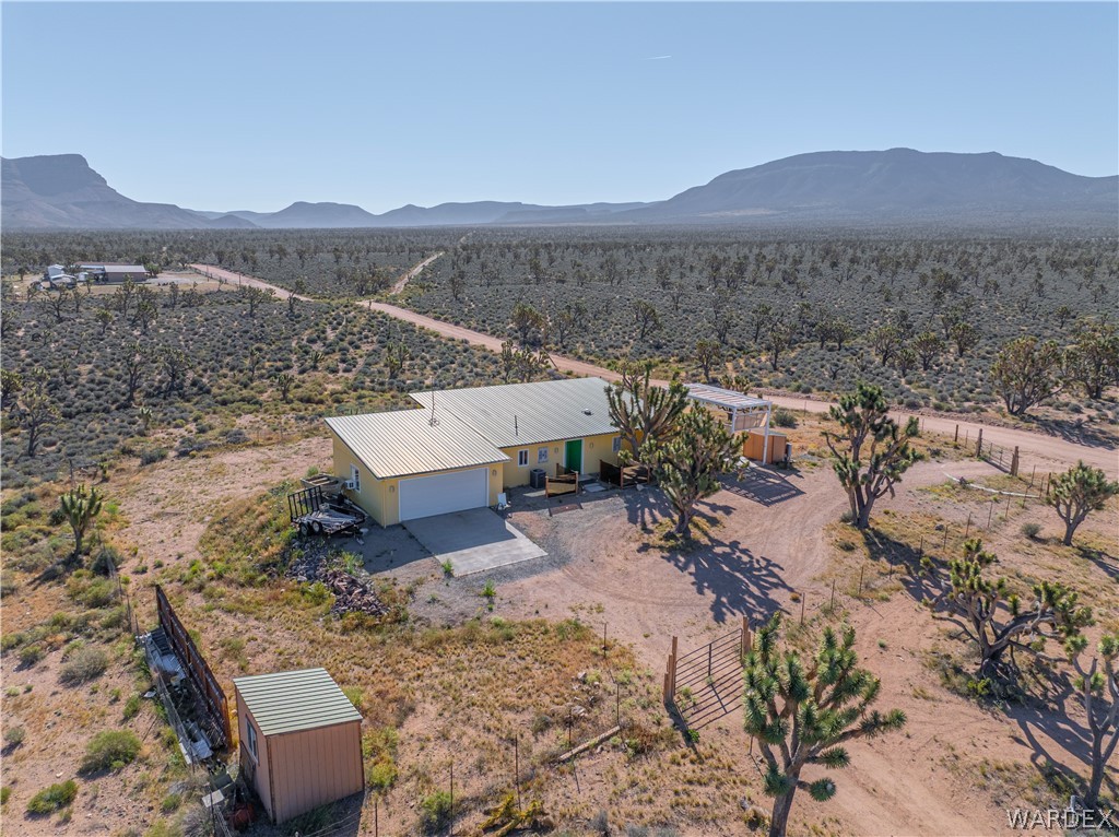 26512 North Yucca Road Meadview, AZ 86444 - Photo 6 of 38 The property features a yellow exterior and a light-colored metal roof