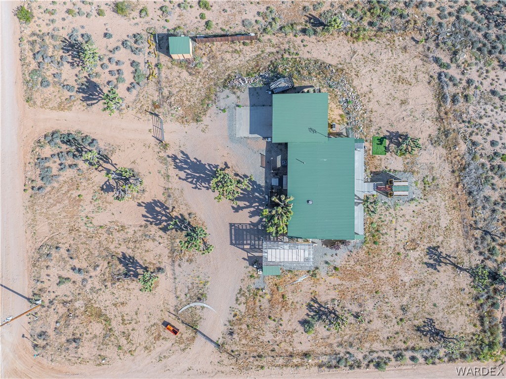 26512 North Yucca Road Meadview, AZ 86444 - Photo 7 of 38 This property features a structure with a green roof, a detached shed, and a gated entrance