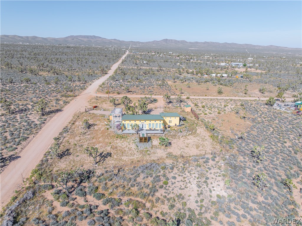 26512 North Yucca Road Meadview, AZ 86444 - Photo 9 of 38 Aerial view of the property, showcasing the single-story structure with a light-colored exterior and a green roof