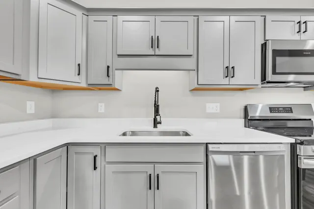 a close view of a sink and mirror in a room
