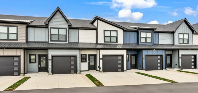 a view of a white house with large windows