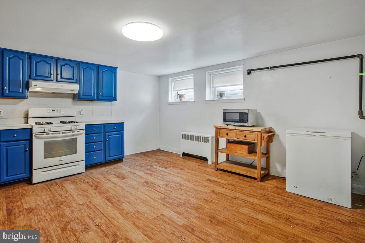 3040 Federal Street Baltimore, MD 21213 - Photo 27 of 41 a kitchen with a stove and a refrigerator