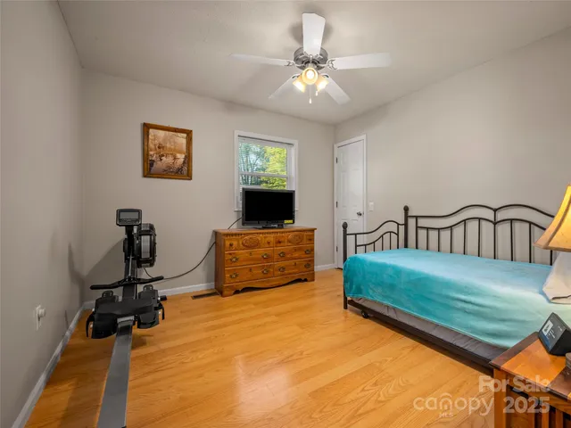 a bedroom with furniture and a flat screen tv