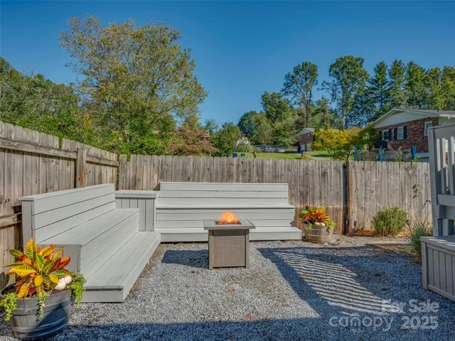 a view of a backyard with sitting area