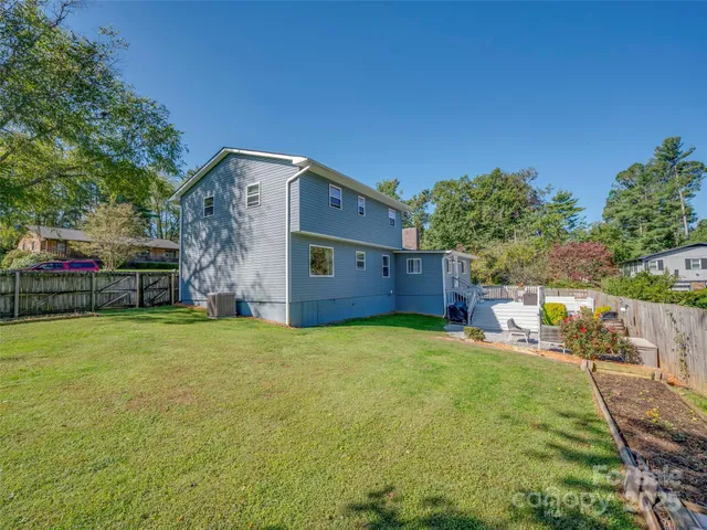 a backyard of a house with barbeque oven fire pit table and chairs
