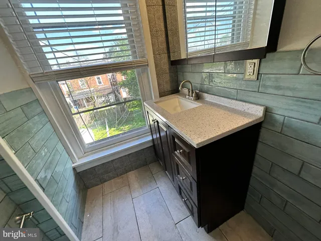 a kitchen with a sink a window a washer and dryer