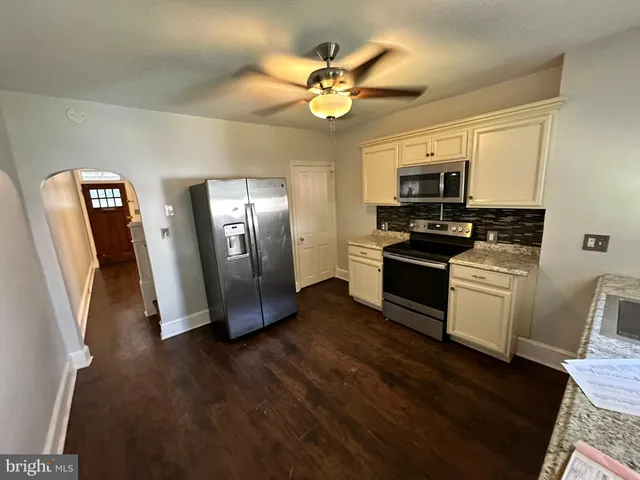 a kitchen with stainless steel appliances a refrigerator a stove top oven a sink and dishwasher