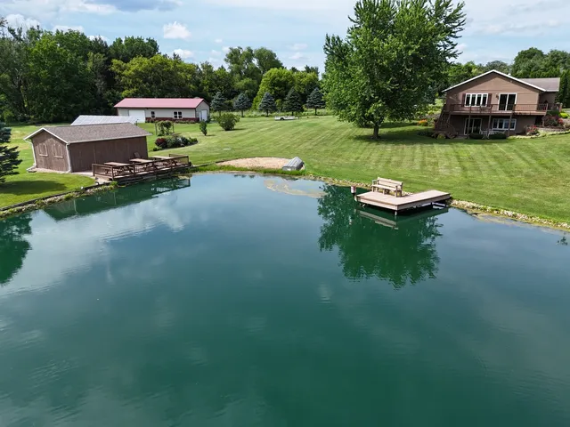 a view of a house with garden space and a car parked on the road