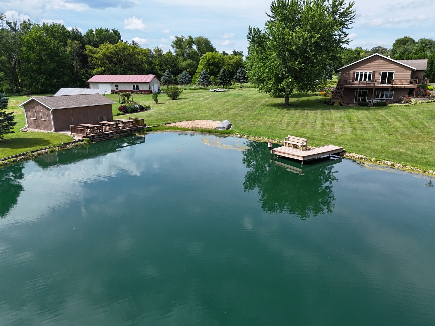 a view of a house with garden space and a car parked on the road