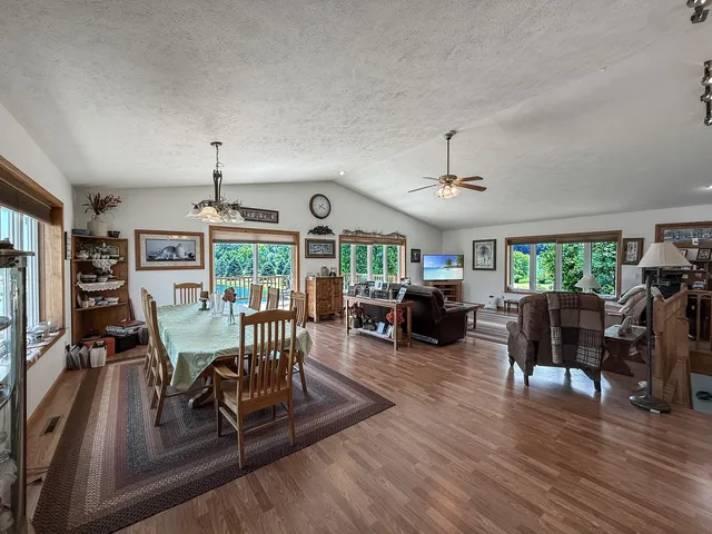 a living room with furniture a chandelier and a flat screen tv