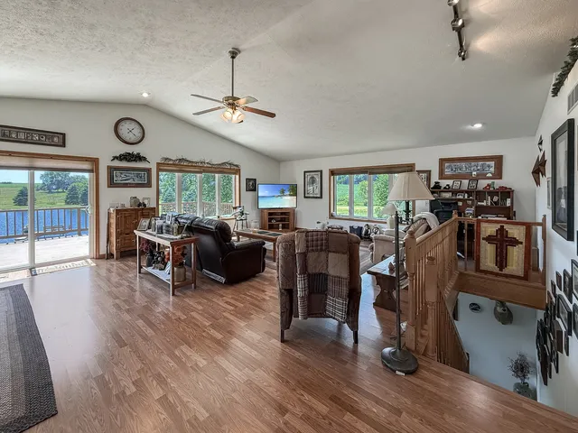 a living room with furniture a wooden floor and a fireplace