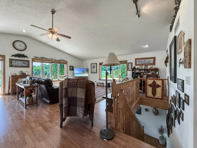 a living room with furniture fireplace and a large window