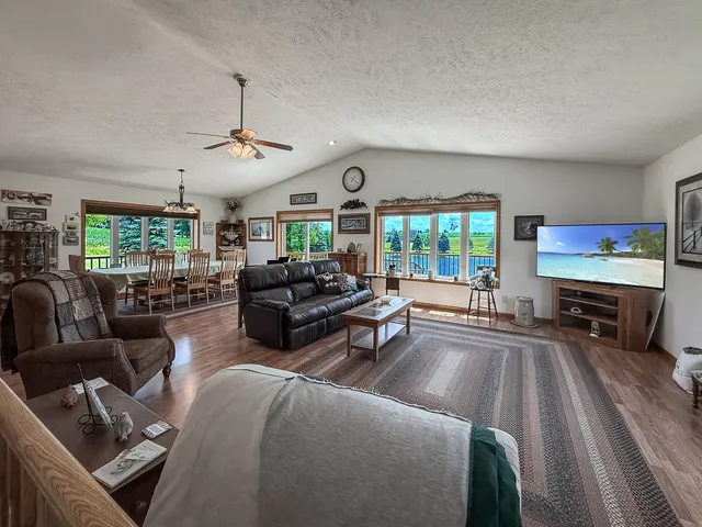 a living room with lots of furniture and kitchen view
