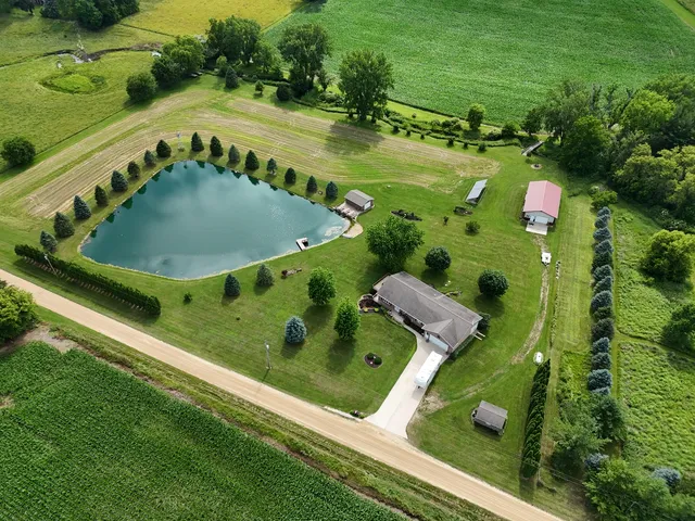 an aerial view of a residential houses with outdoor space and street view