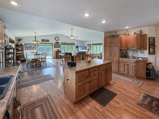 a living room with lots of furniture and kitchen view