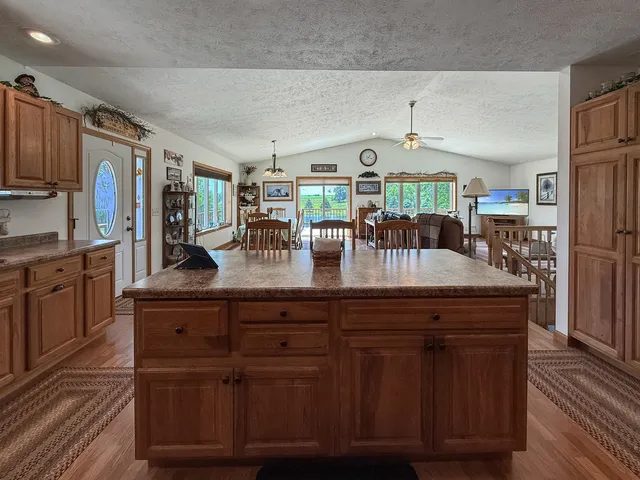 a bedroom with a bed flat screen tv and a large window