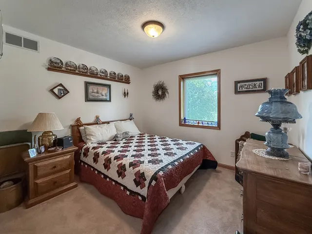 a spacious bathroom with a toilet a sink and shower