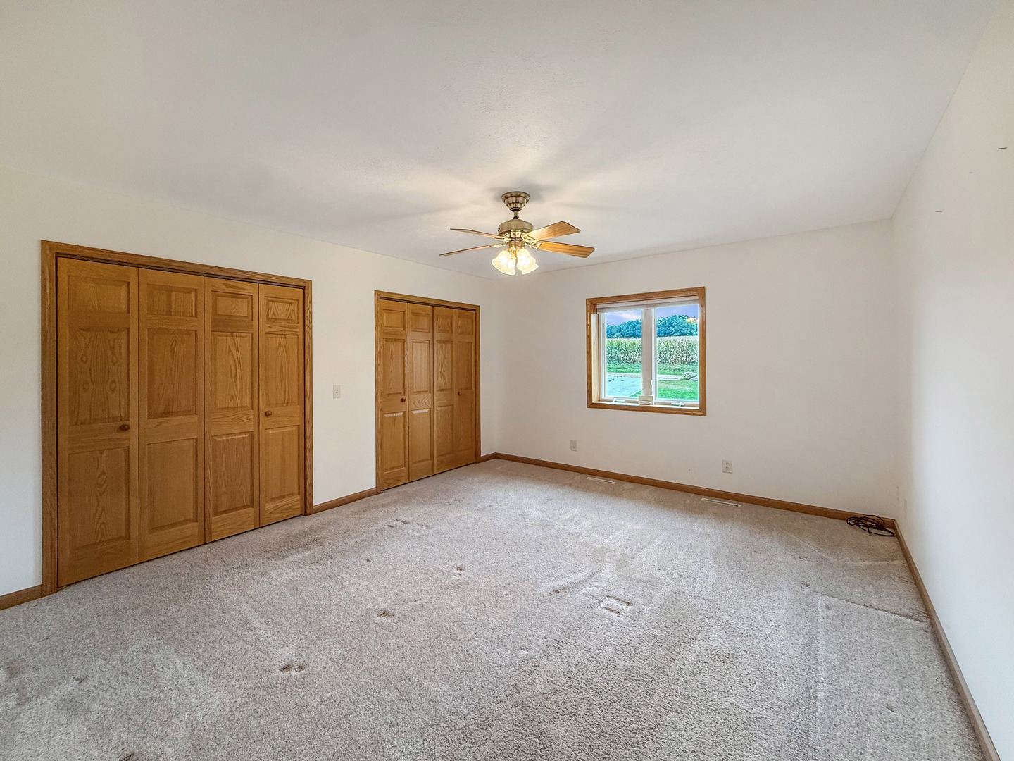 5782 North Brown Road Dakota, IL 61018 - Photo 32 of 46 an empty room with windows and a ceiling fan