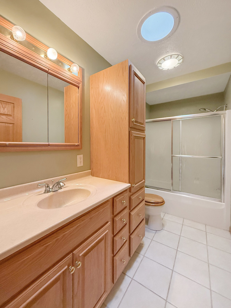5782 North Brown Road Dakota, IL 61018 - Photo 32 of 49 a bathroom with a sink a toilet and shower