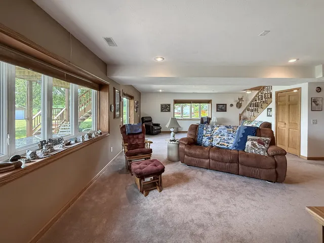 a living room with furniture gym equipment and a large window