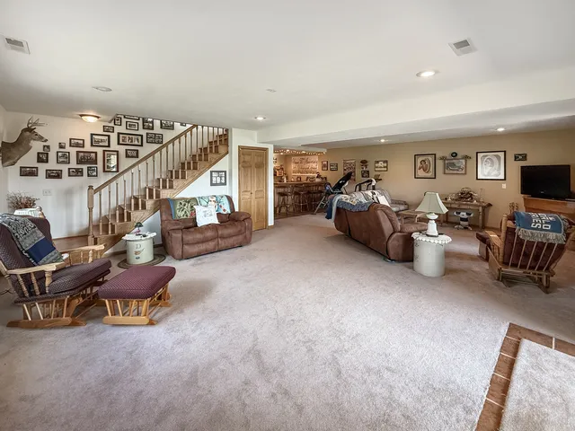 a dining hall with stainless steel appliances granite countertop a table and chairs
