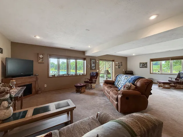 a bedroom with a bed a mirror and a window