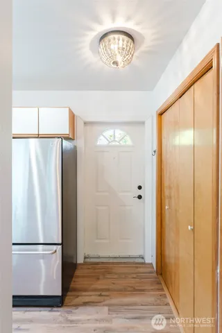a view of a refrigerator in kitchen and wooden floor