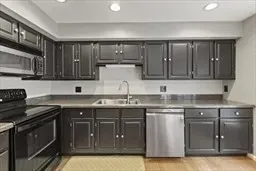 a kitchen with stainless steel appliances granite countertop a sink stove and cabinets