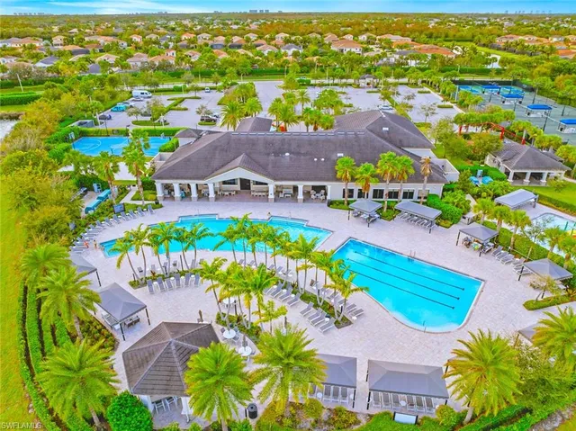 an aerial view of residential houses with outdoor space and swimming pool