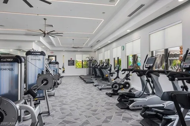 a room with gym equipment and wooden floor