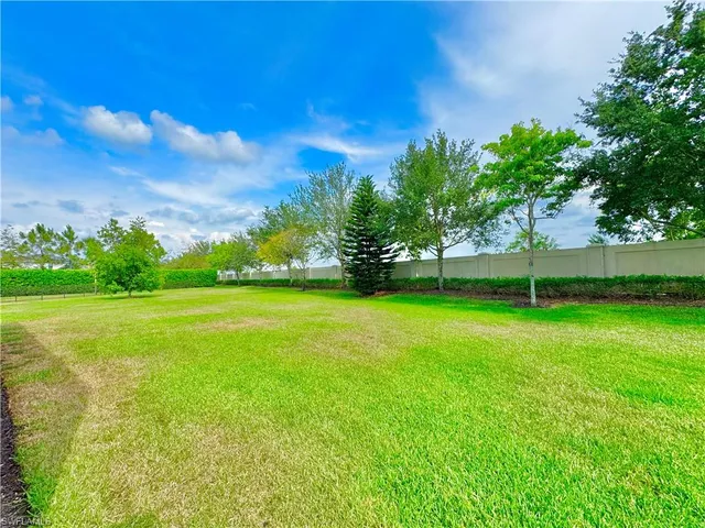 a view of an empty room with a ceiling fan and window