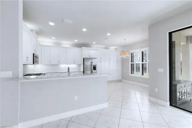 an empty room with fan and windows