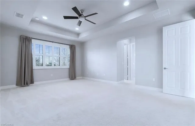 a spacious bathroom with a granite countertop sink mirror and bathtub