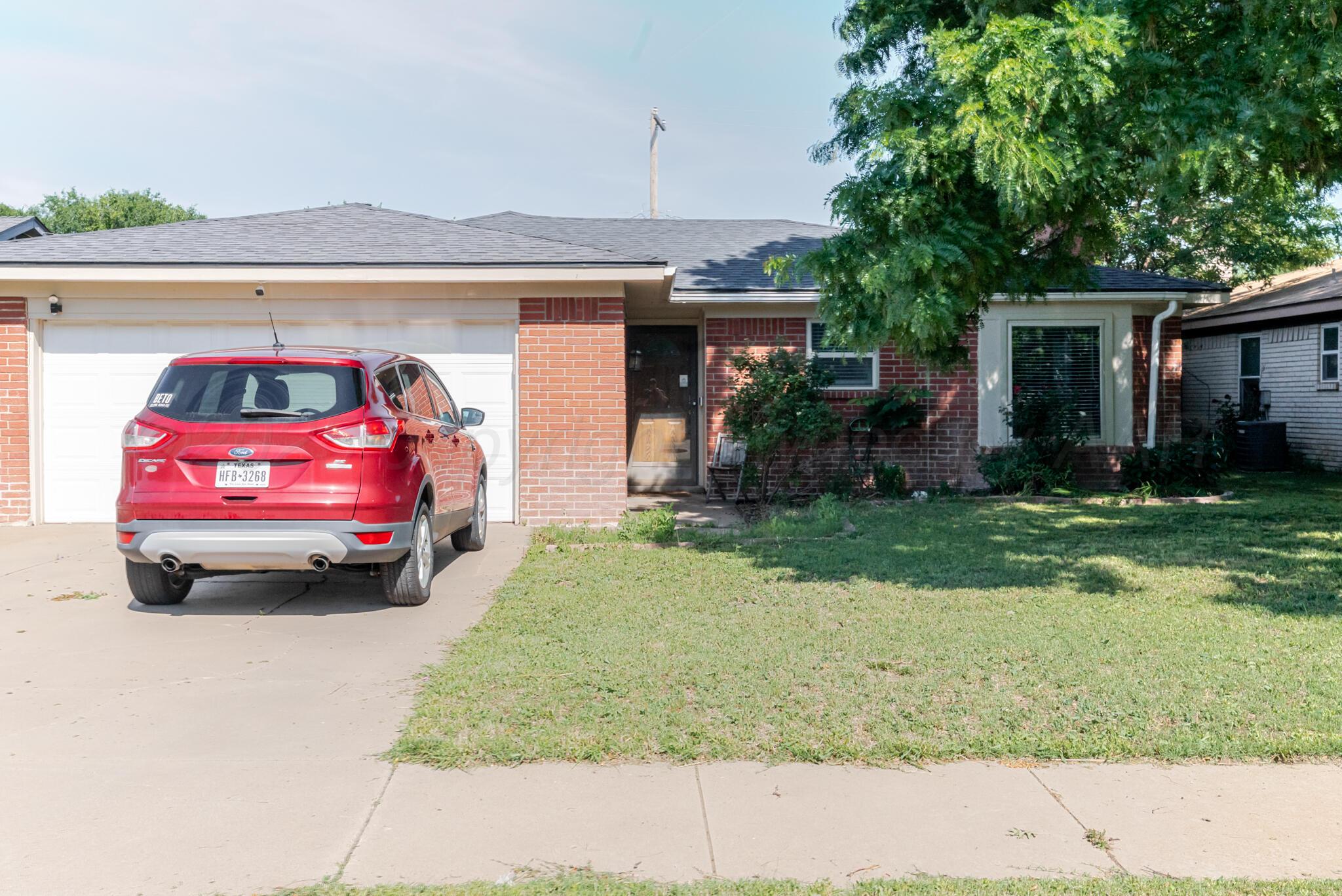 5210 South Milam Street Amarillo, TX 79110 - Photo 1 of 22 a front view of a house with a yard