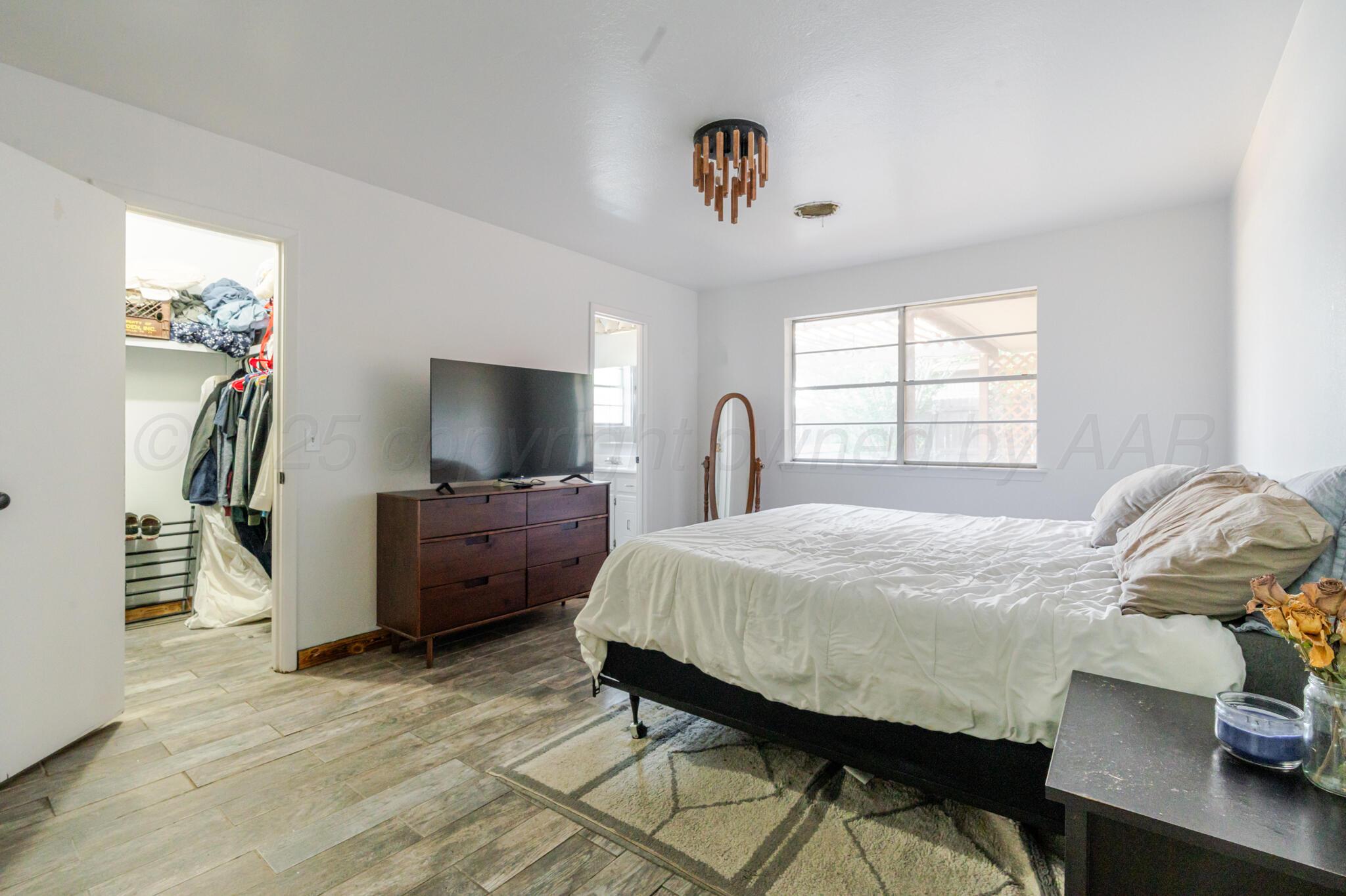 5210 South Milam Street Amarillo, TX 79110 - Photo 15 of 22 a bedroom with a bed and a flat screen tv