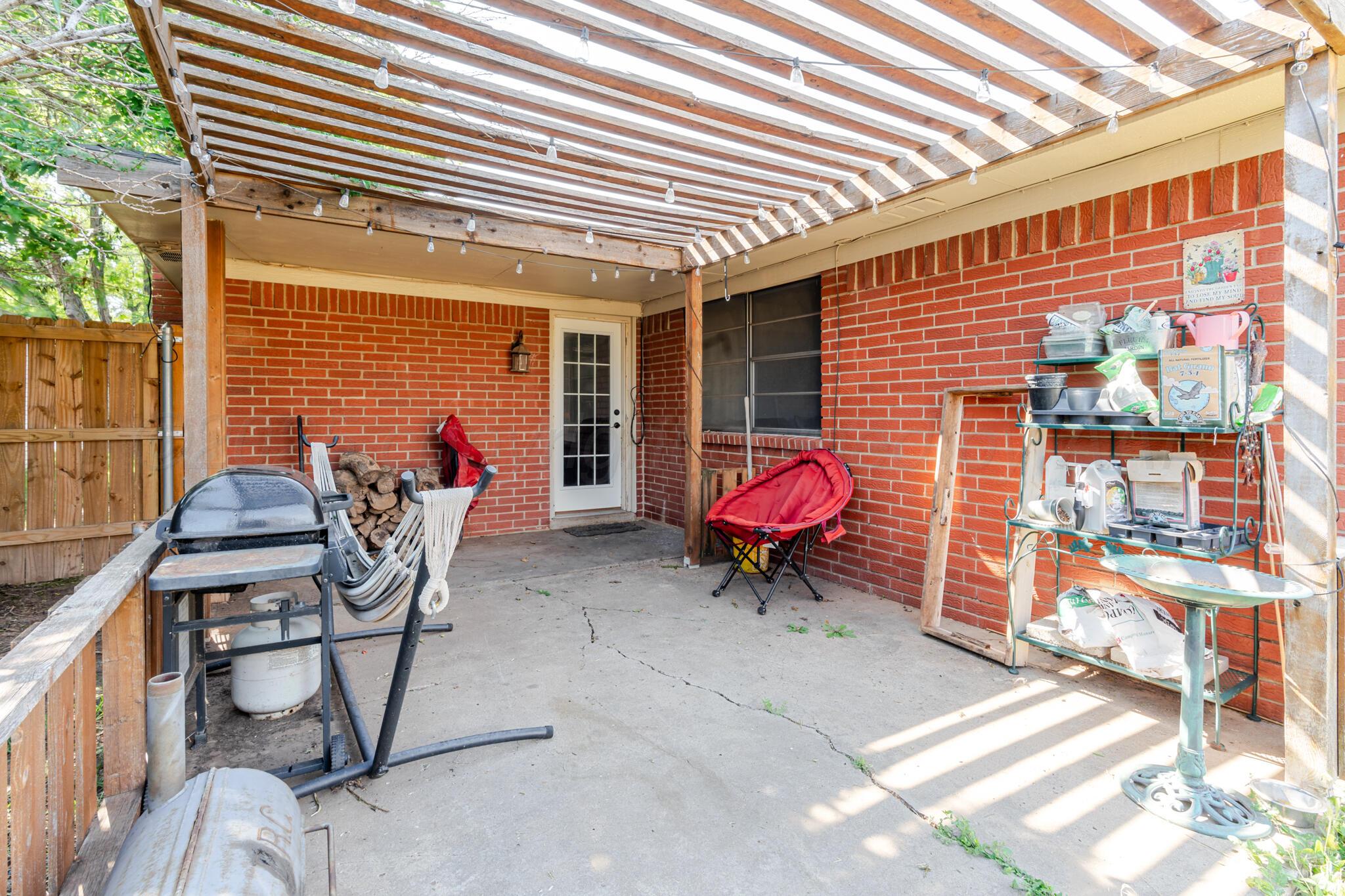 5210 South Milam Street Amarillo, TX 79110 - Photo 21 of 22 a backyard of a house with table and chairs
