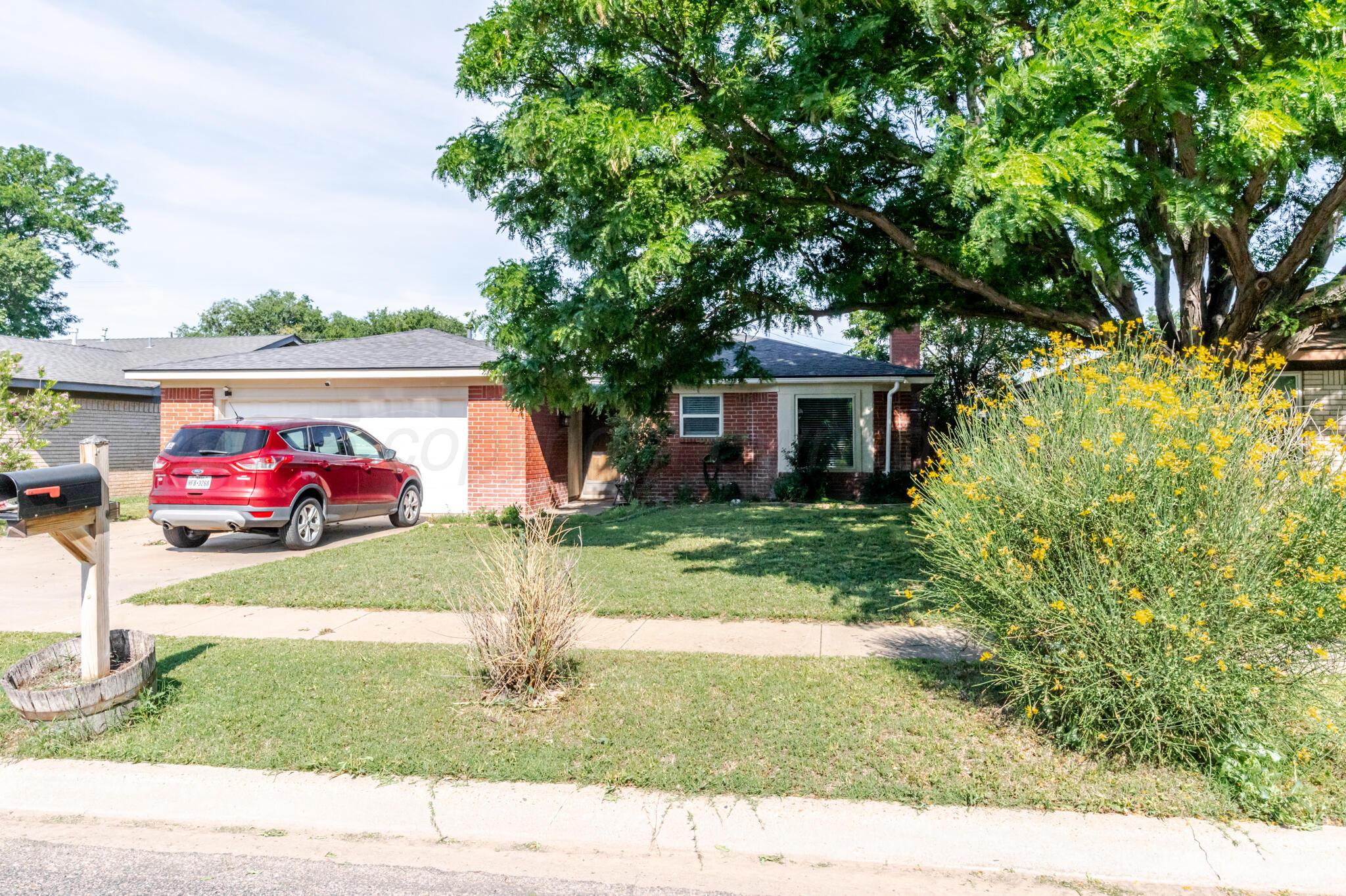 5210 South Milam Street Amarillo, TX 79110 - Photo 3 of 22 a front view of a house with garden