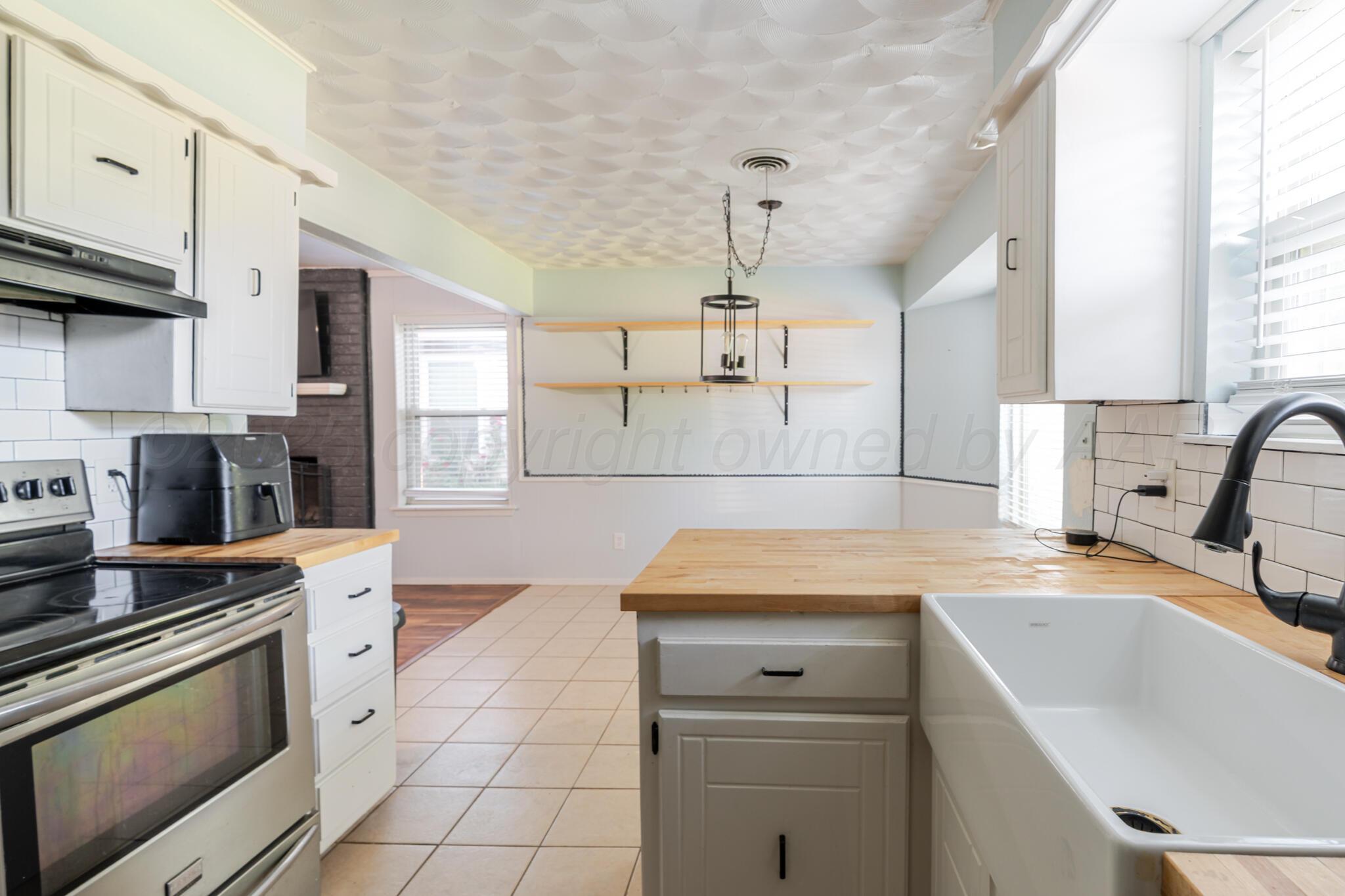5210 South Milam Street Amarillo, TX 79110 - Photo 4 of 22 a kitchen with a sink appliances and cabinets