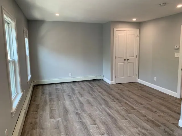 wooden floor in an empty room with a window