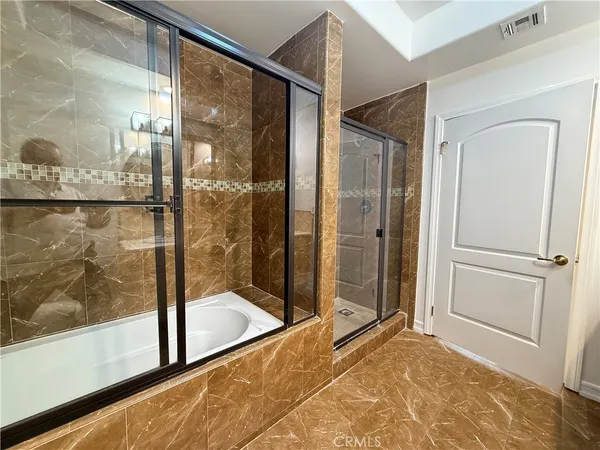 a view of a bathroom with a glass shower door