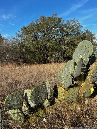 a sign board with a house in the background