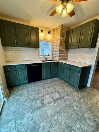 a kitchen with stainless steel appliances granite countertop a sink and a microwave