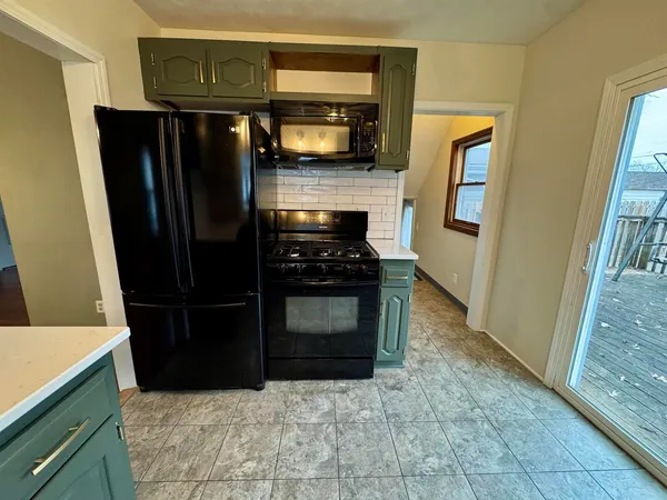 a kitchen with granite countertop a refrigerator and a stove