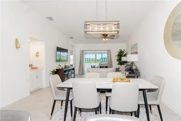 a view of a dining room with furniture wooden floor and chandelier
