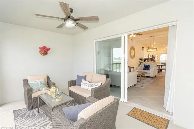 a living room with furniture and a floor to ceiling window