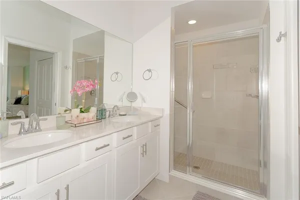 a bathroom with a granite countertop sink mirror and shower