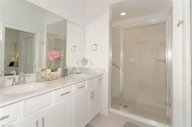a bathroom with a granite countertop sink mirror and shower