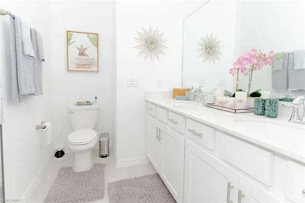 a bathroom with a sink a vanity and a toilet