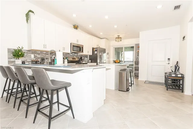 a kitchen with a table chairs and a refrigerator