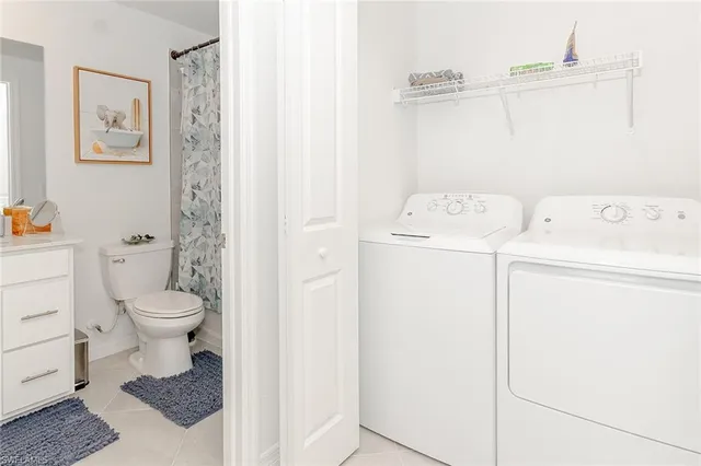 a bathroom with a granite countertop toilet and a shower